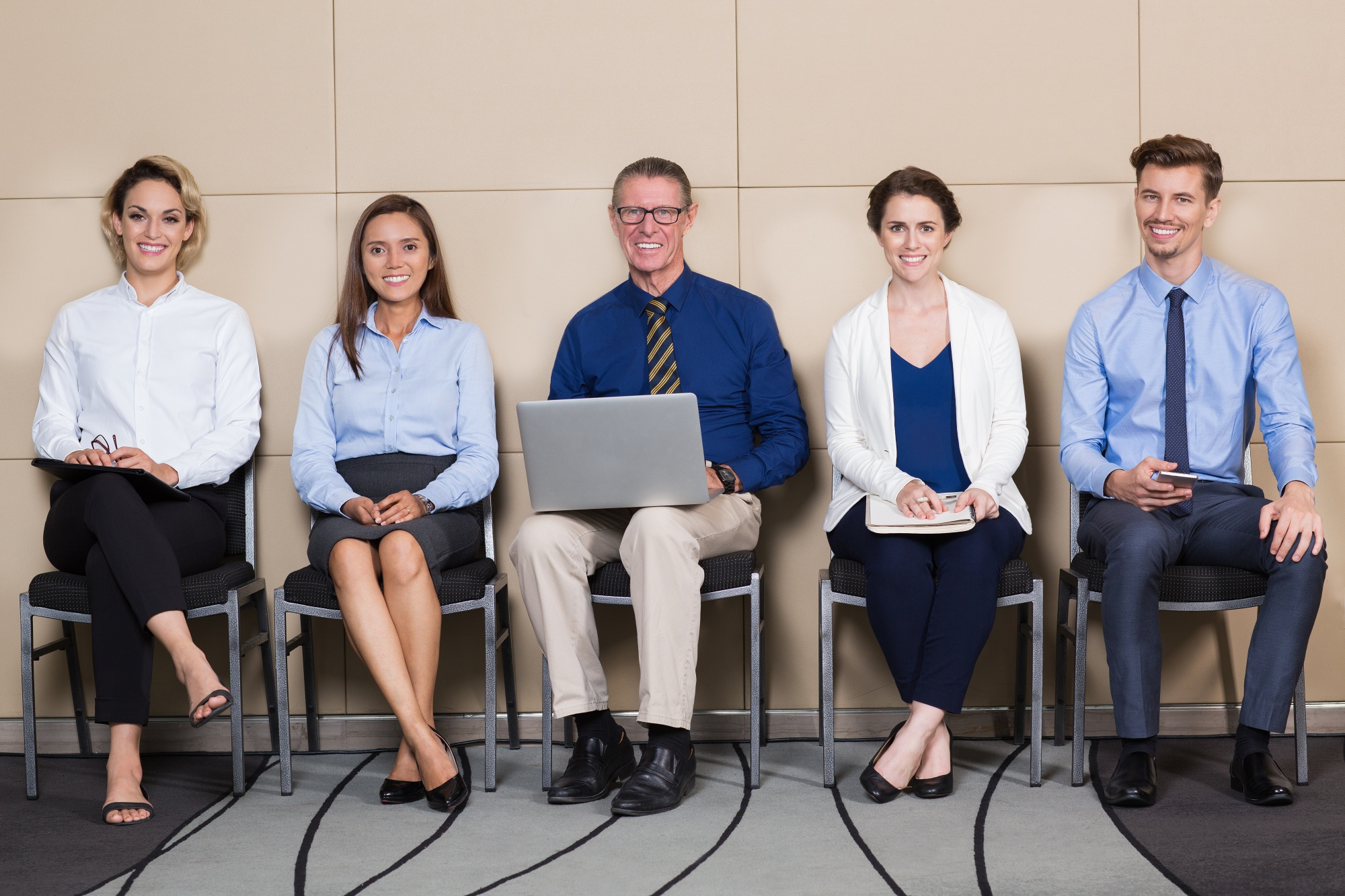 five-smiling-applicants-sitting-waiting-room